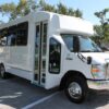 A white bus parked in the parking lot.