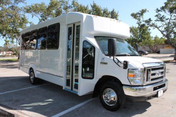 A white bus parked in the parking lot.