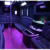 A black and purple party bus with leather seats.