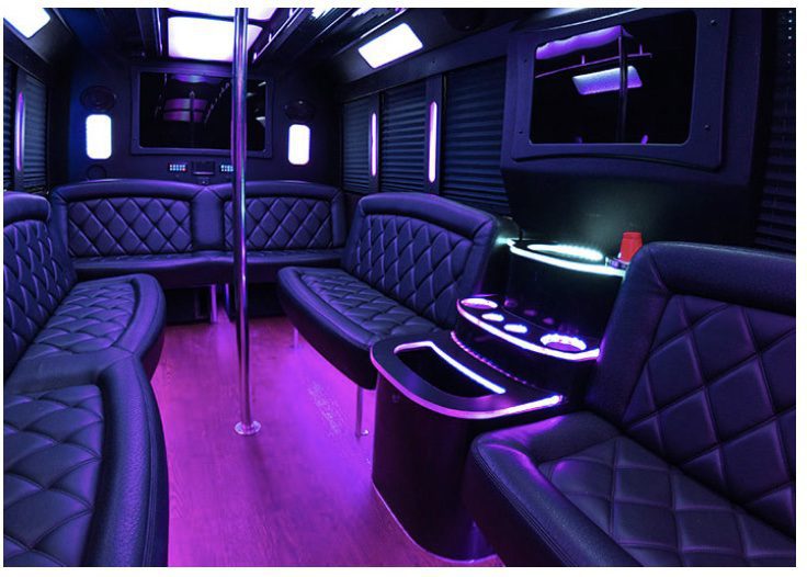 A black and purple party bus with leather seats.