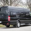 A black van parked on the side of a road.