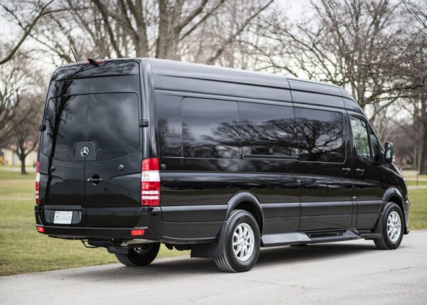 A black van parked on the side of a road.