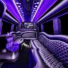 A limo with purple lights and black leather seats.