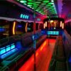 A party bus with neon lights and seats.