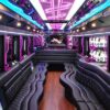 A very long limo with purple lights on the walls.