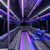 A bus with purple lights and leather seats.