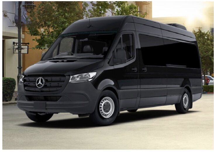 A black mercedes benz van parked in front of a building.