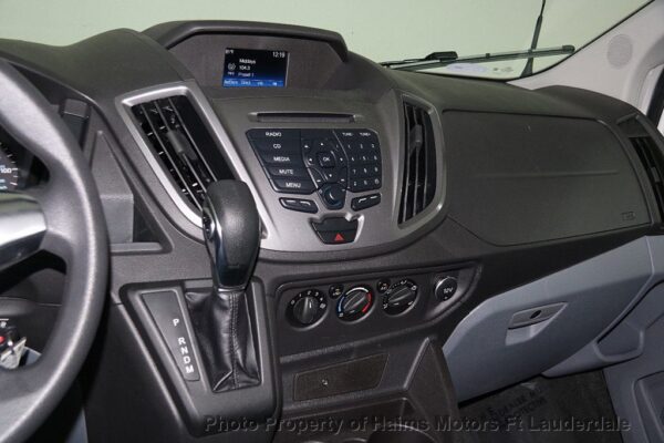 A car dashboard with the steering wheel and controls.