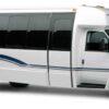 A white bus with blue and black stripes on the side.