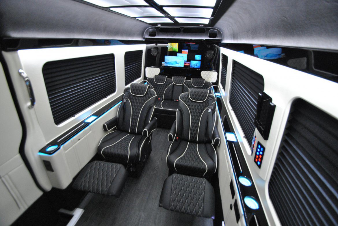 A bus with black and white seats in the back.