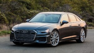 A black car is parked on the side of the road.