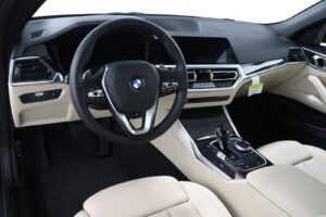 A car with beige leather interior and steering wheel.