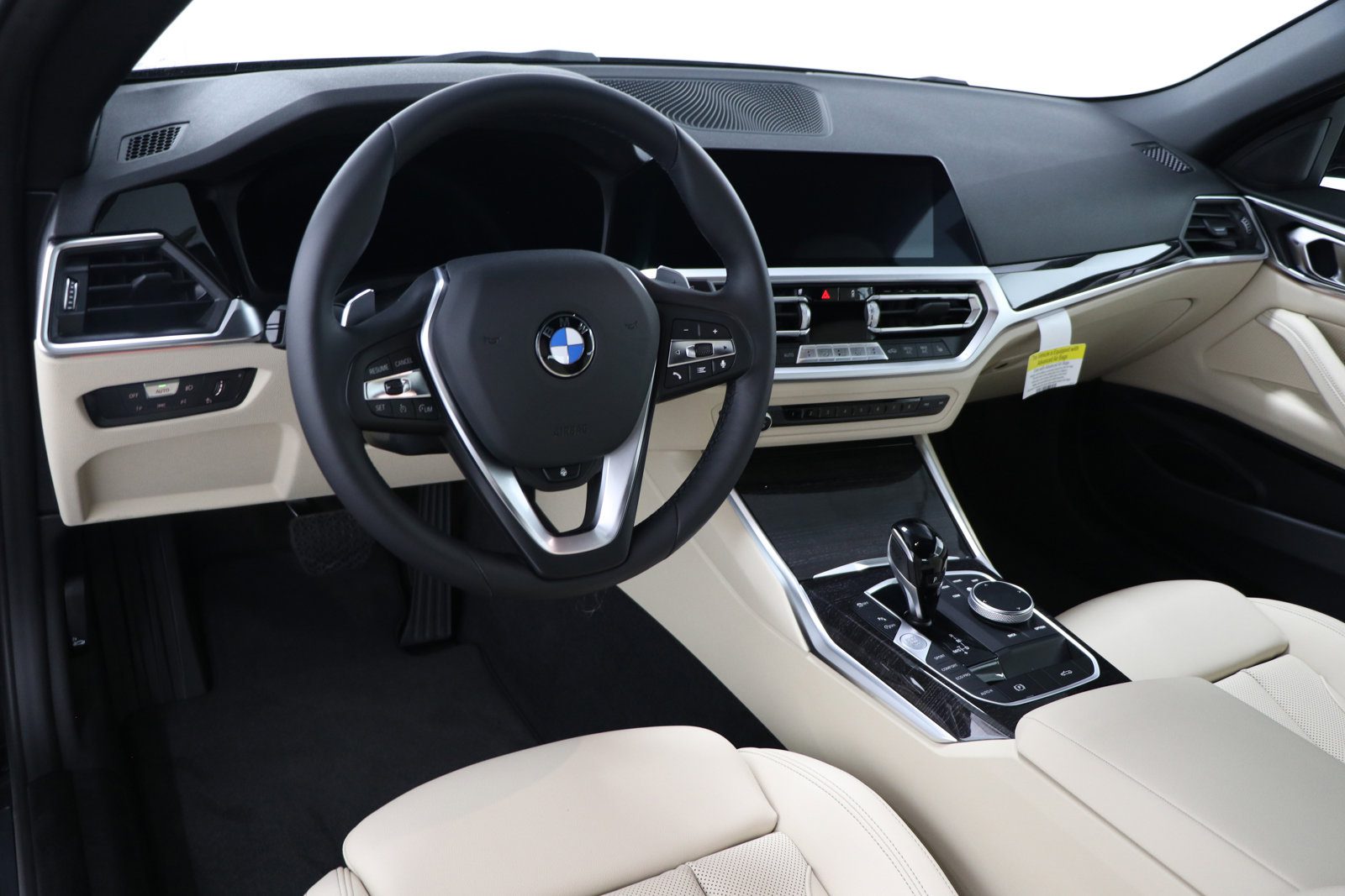 A car with beige leather interior and steering wheel.