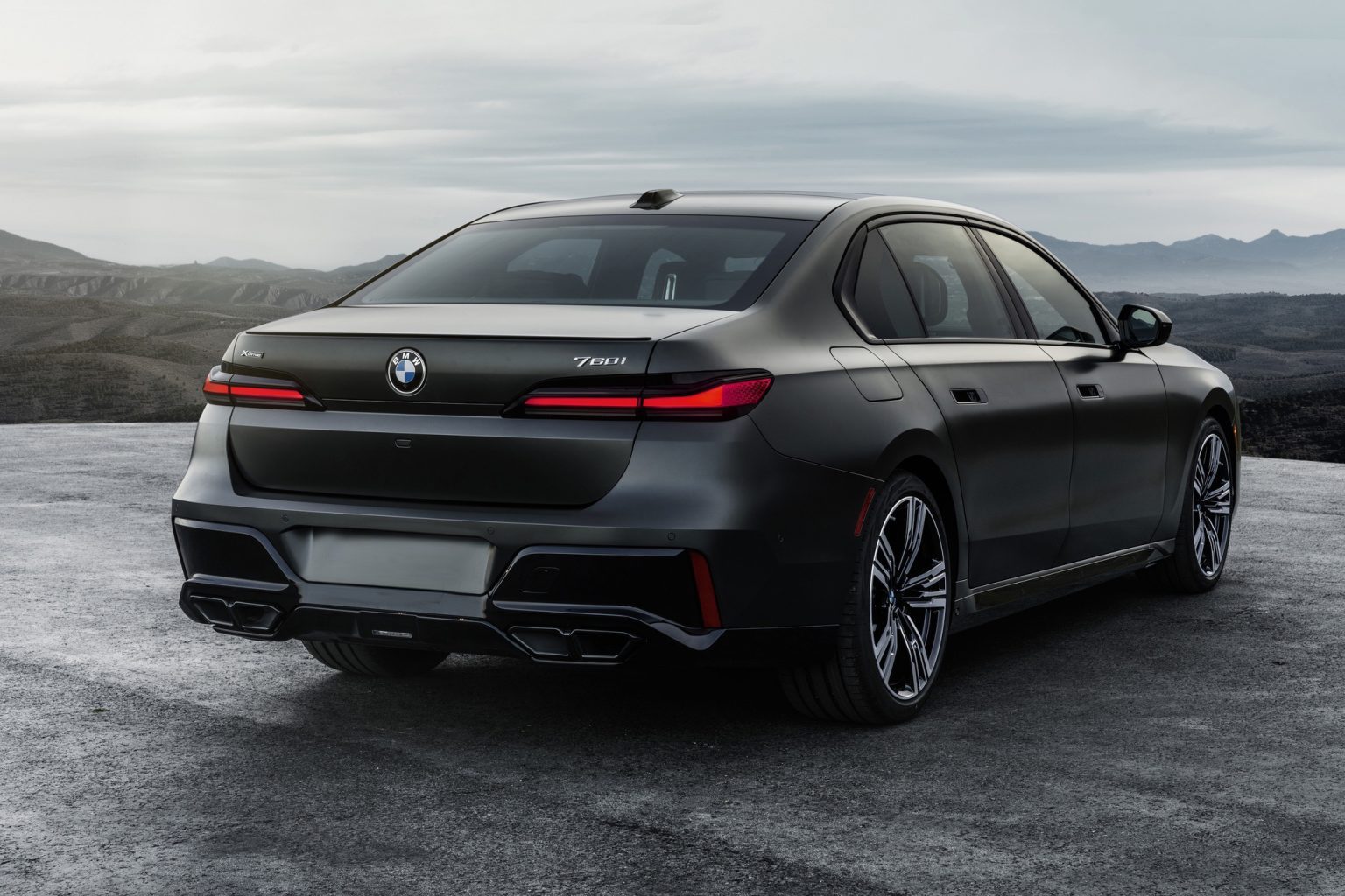 A black bmw is parked in the parking lot.