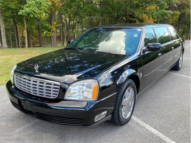 A black limo is parked in the parking lot.