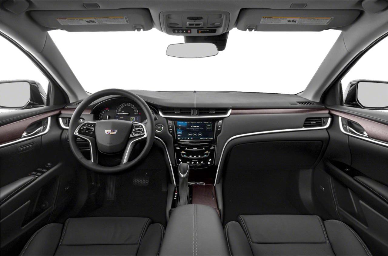 A dashboard and steering wheel of a car.