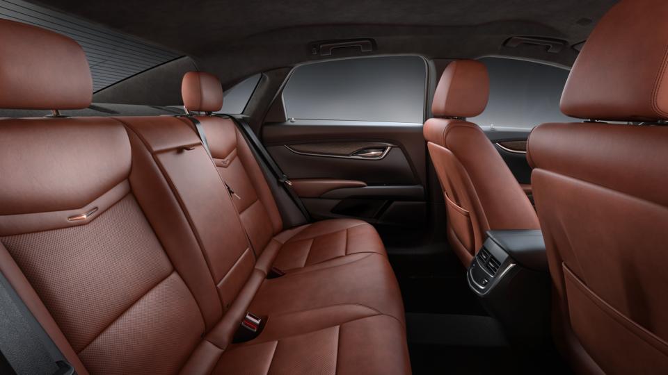 A car with brown leather seats and the back seat folded down.