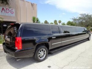 A black limo is parked in the street.