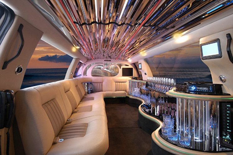 A limo with many chairs and tables in it