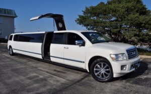 A white limo is parked in the parking lot.