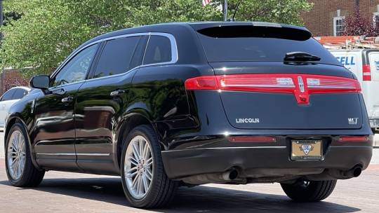 A black lincoln mkt is parked in the parking lot.