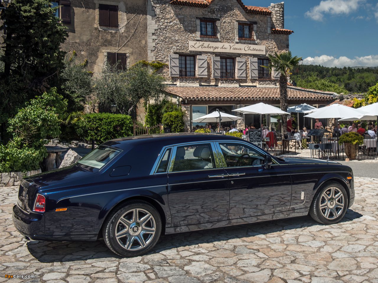 A black car parked in front of a building.