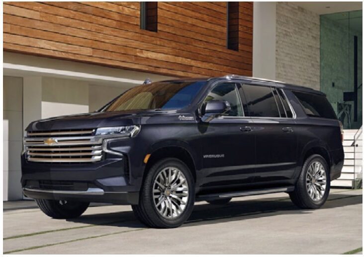 A black suv parked in front of a building.