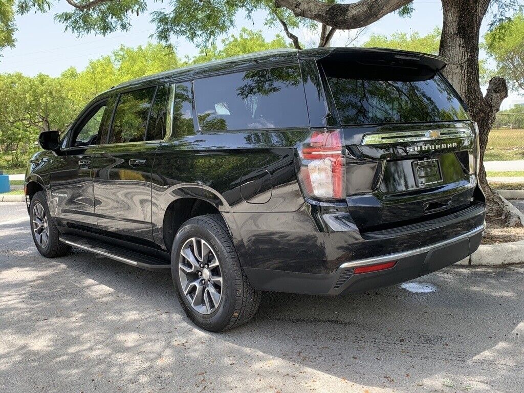 A black suv parked on the side of a road.