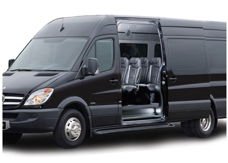 A black van with the doors open and seats folded down.