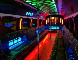 A neon lit party bus with many seats.