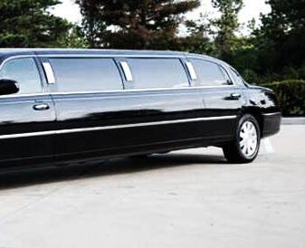 A black limo is parked in the parking lot.