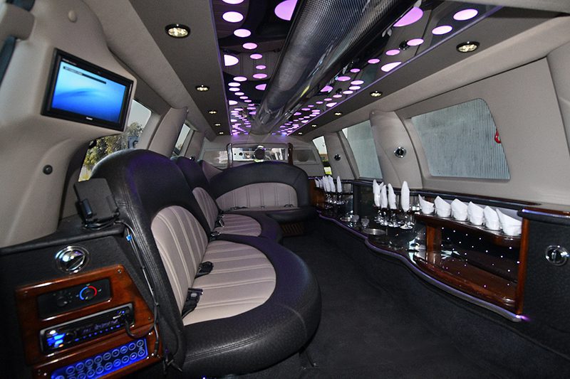 A limo with purple lights and black leather seats.