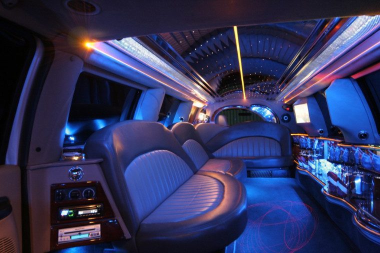 A limo with blue lights and leather seats.