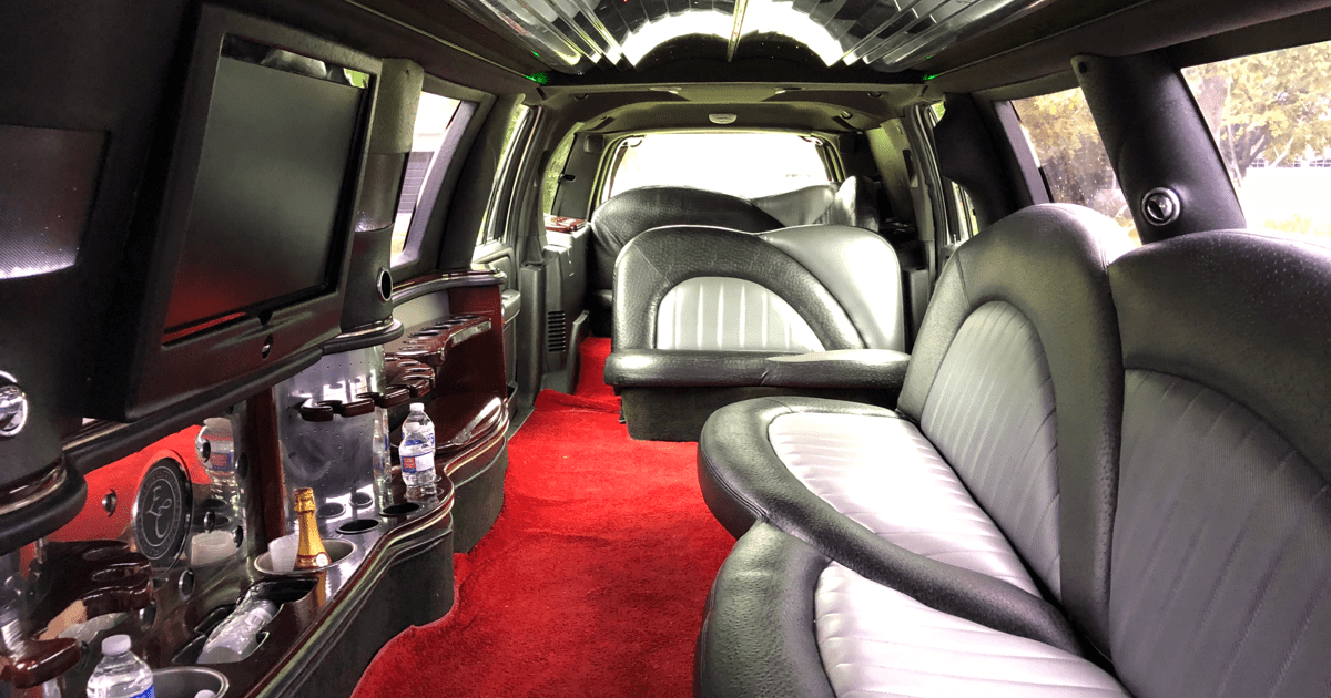 A car with red carpet and leather seats.