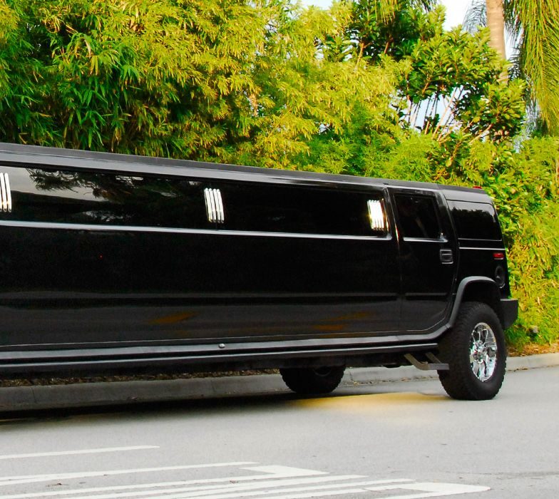 A black limo driving down the street