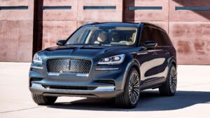 A black lincoln aviator parked in front of a building.