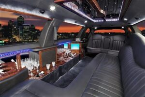 A limo with a bar and chairs in it