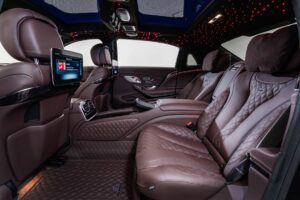 A car with brown leather seats and a large screen.