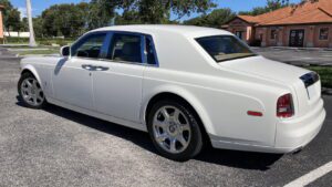 A white car parked on the side of a road.