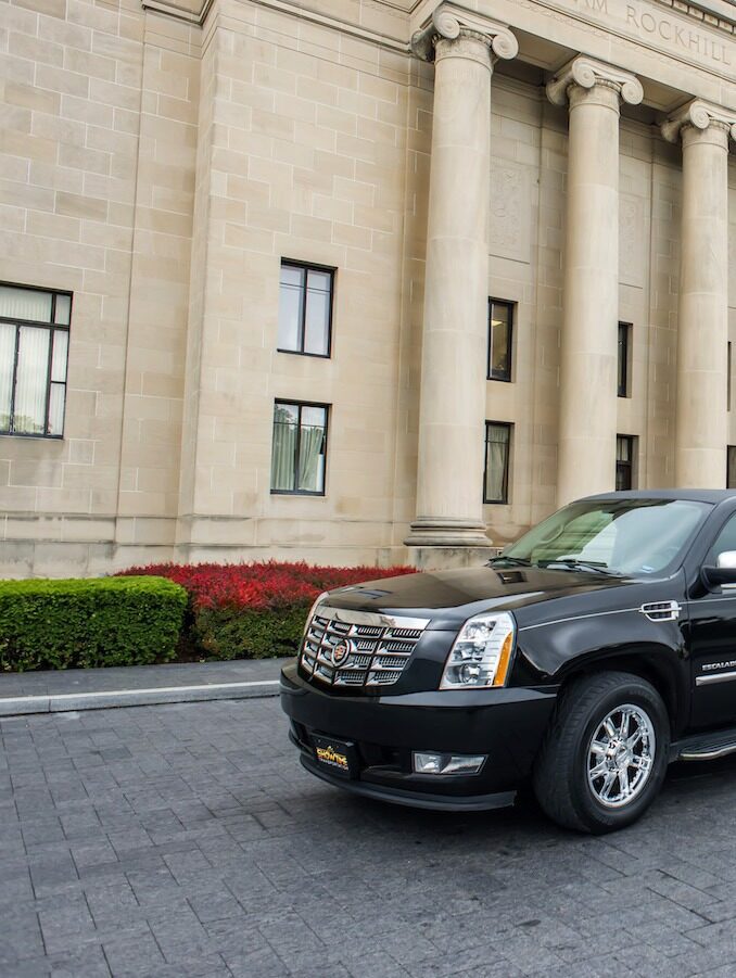 A black suv parked in front of a building.