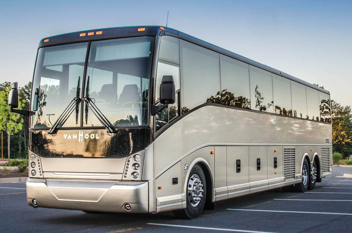 A large white bus is parked in the parking lot.