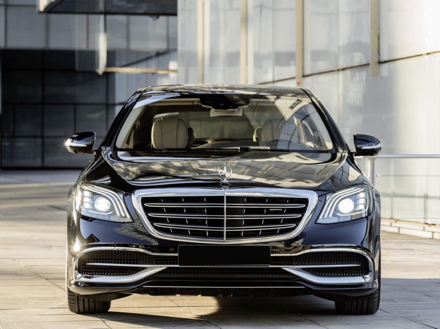 A black car parked in front of a building.