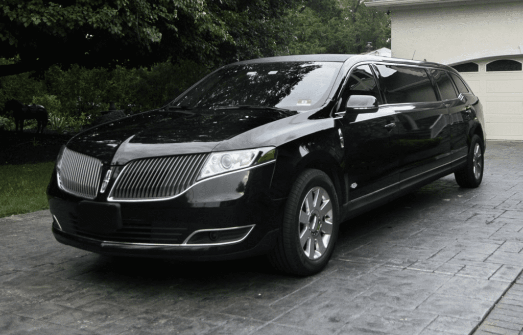 A black limo is parked on the street.