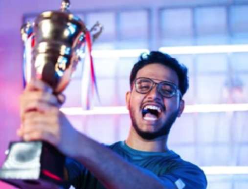 A man holding up a trophy in front of a crowd.