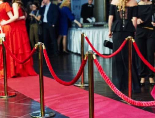 A red carpet with people standing around it