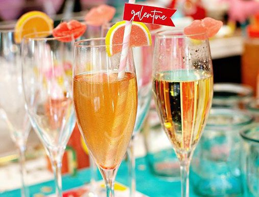 A table with several glasses of wine and champagne.