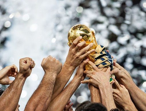 A group of people holding up a trophy.