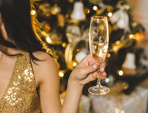 A woman holding up a glass of wine.