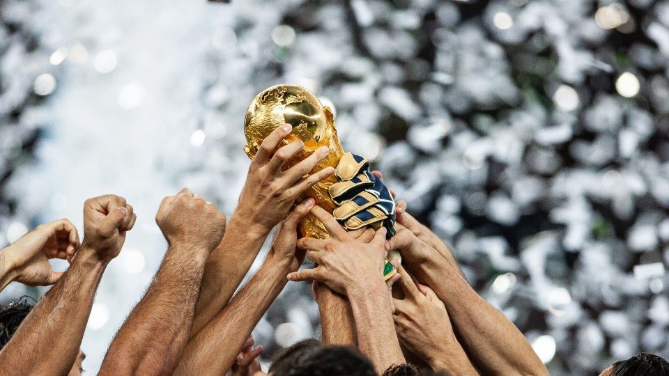 A group of people holding up a trophy.